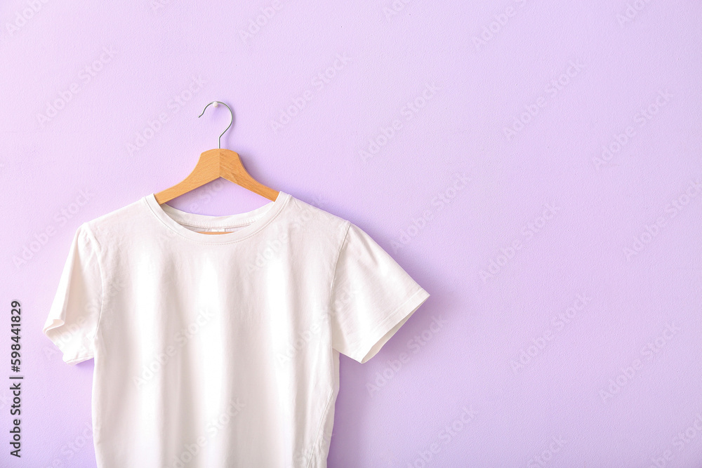 White t-shirt hanging on lilac wall