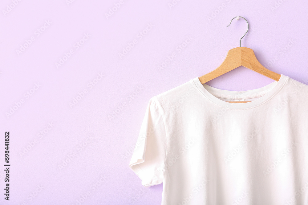 White t-shirt hanging on lilac wall