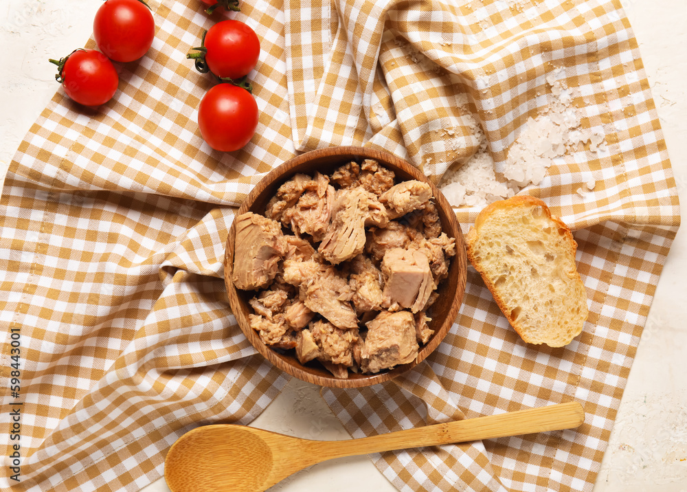 Bowl with delicious canned tuna on crumpled napkin, closeup