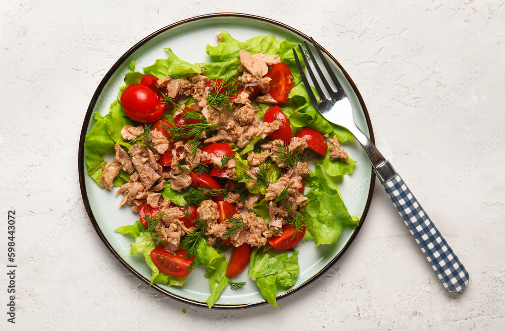 Plate with delicious tuna salad on white table