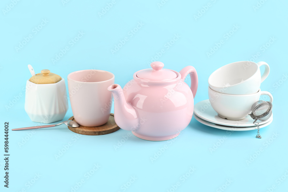 Stylish tea set on blue background