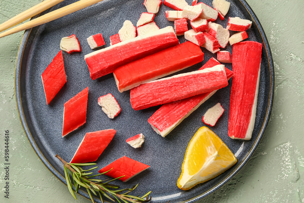 Plate with tasty crab sticks on light background, closeup