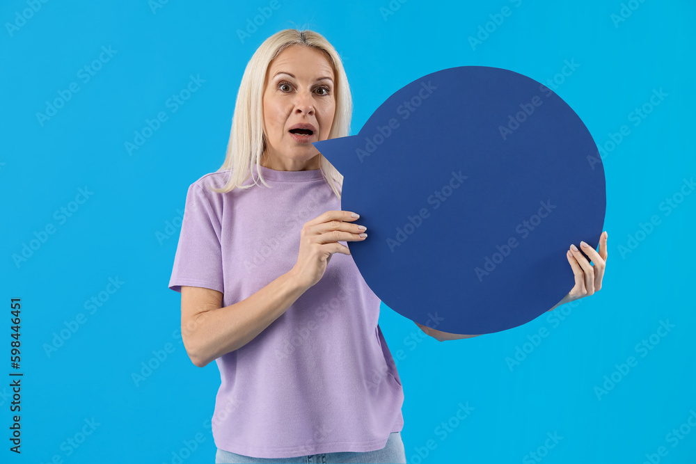 Mature woman with blank speech bubble on blue background