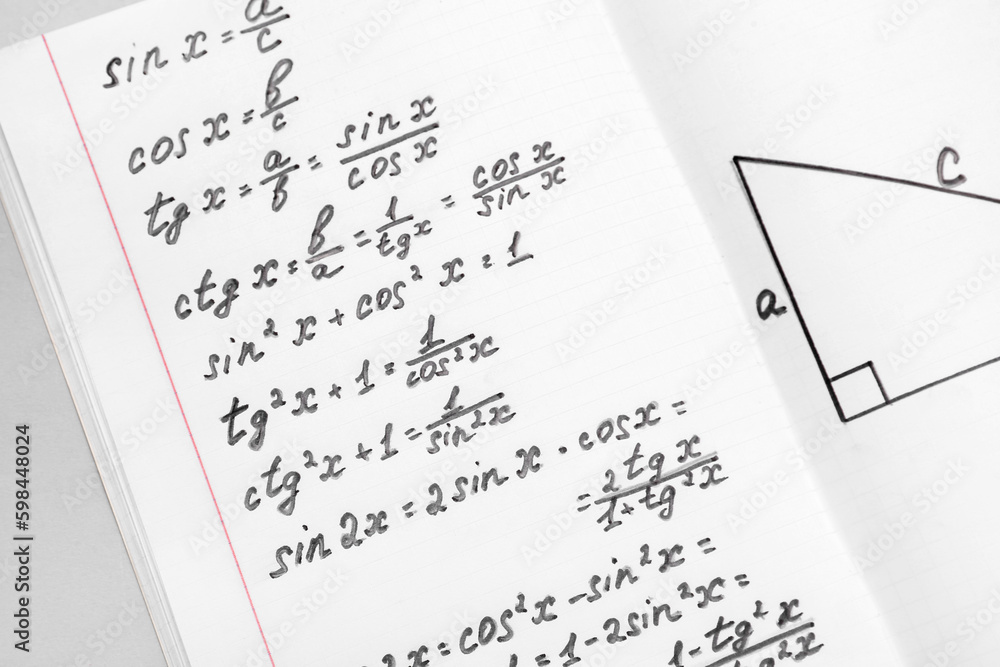 Copybook with maths formulas, closeup