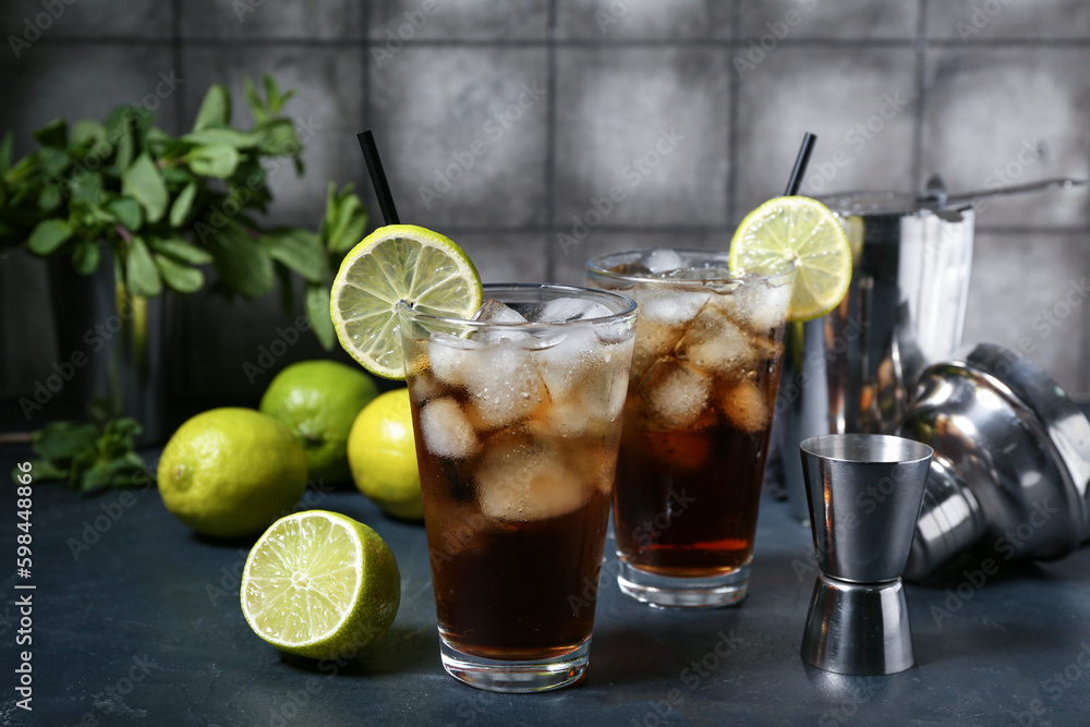 Glasses of cold Cuba Libre cocktail on table