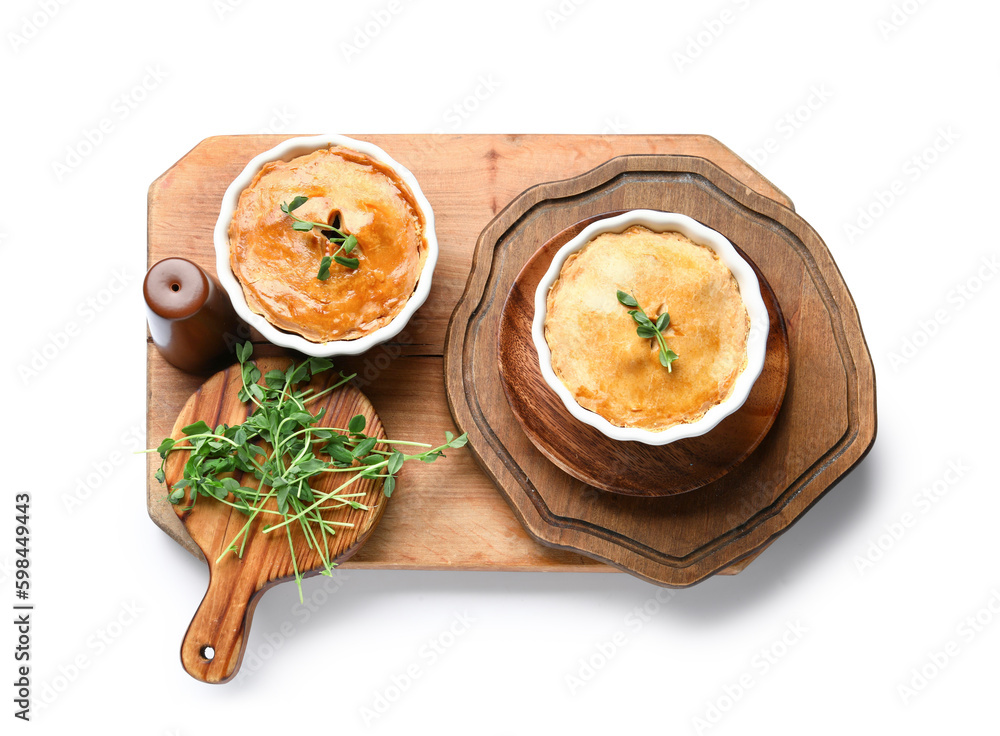 Wooden board with tasty meat pot pies on white background