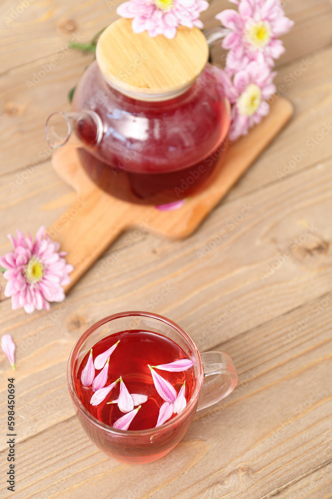 Beautiful tea set with chrysanthemums on wooden table