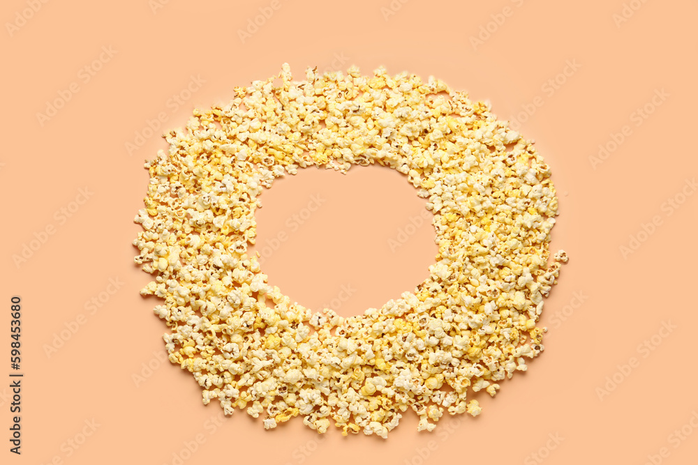 Frame made of crispy popcorn on beige background