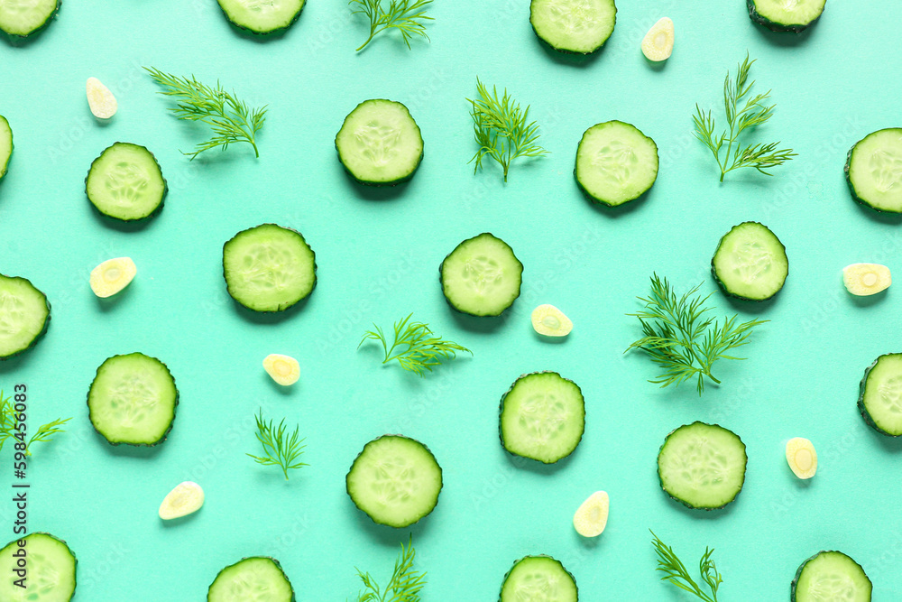 Slices of cucumber with dill and garlic on turquoise background