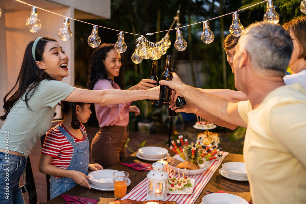 Multi-ethnic big family having fun, enjoy party outdoors in the garden. 