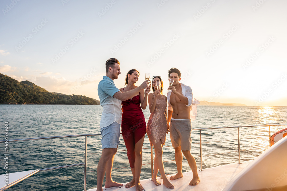 Group of diverse friends drink champagne while having a party in yacht. 