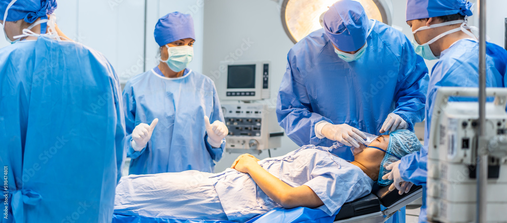 Professional doctors performing surgical operation in operating room. 