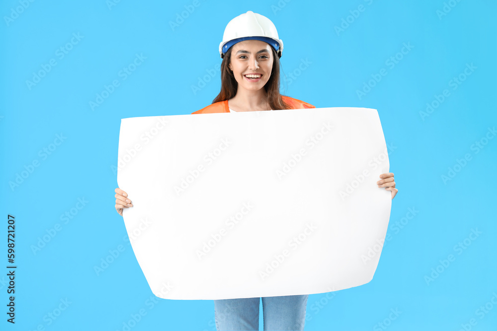 Female engineer with drawing on blue background