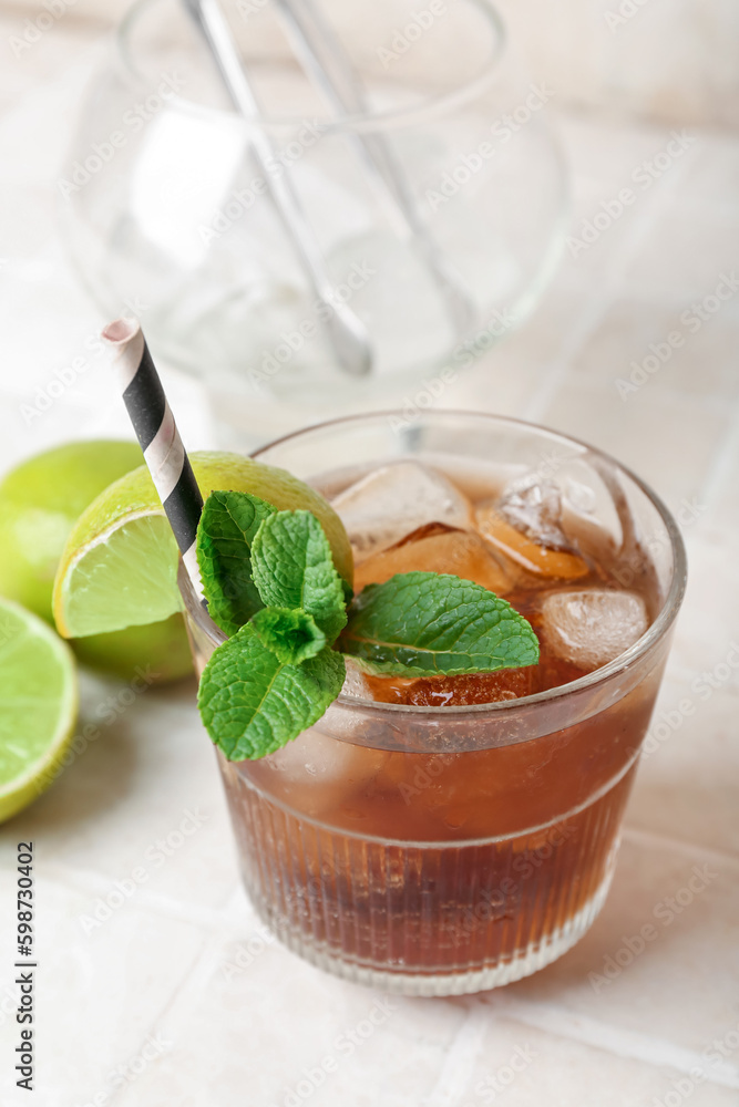 Glass of tasty Cuba Libre cocktail on table