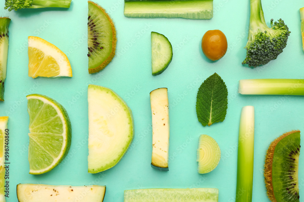 Composition with different fresh fruits and vegetables on green background