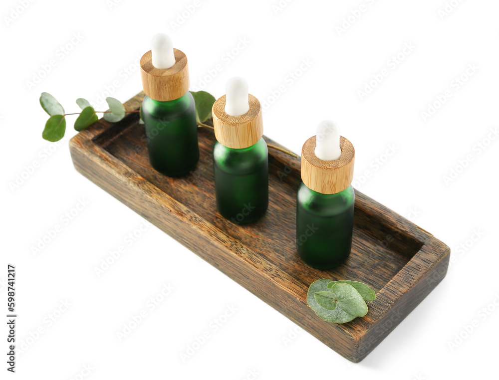 Cosmetic oil with wooden stand and eucalyptus branch on white background