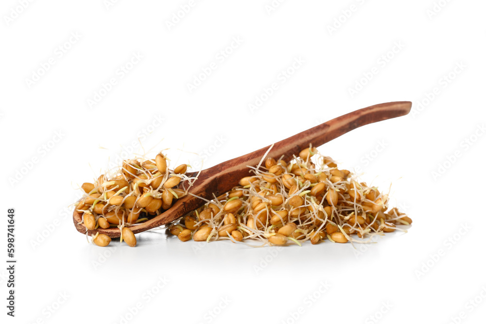 Heap of sprouted wheat and wooden spoon on white background