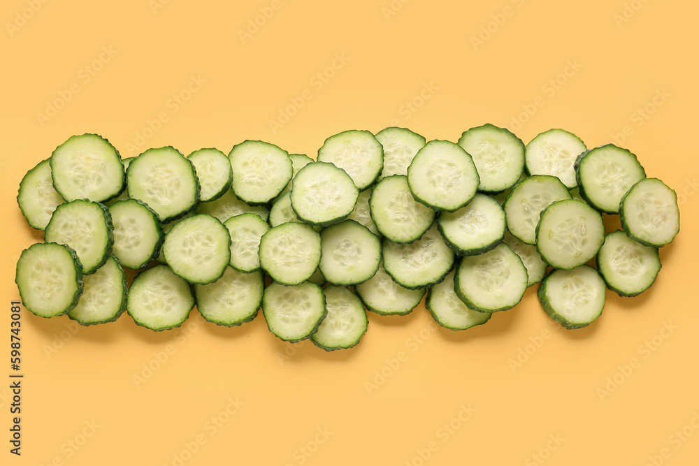 Slices of cucumber on yellow background