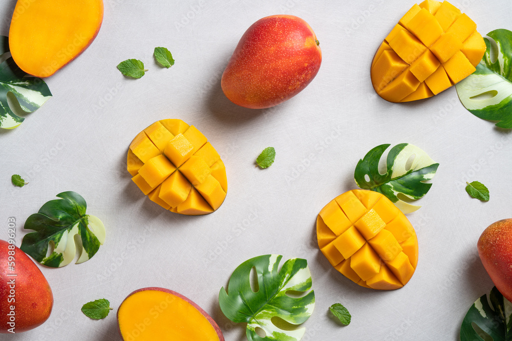 Mango background design concept. Top view Diced fresh mango fruit on gray table.