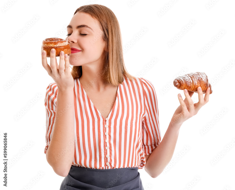 Female baker with tasty croissant and bun on white background