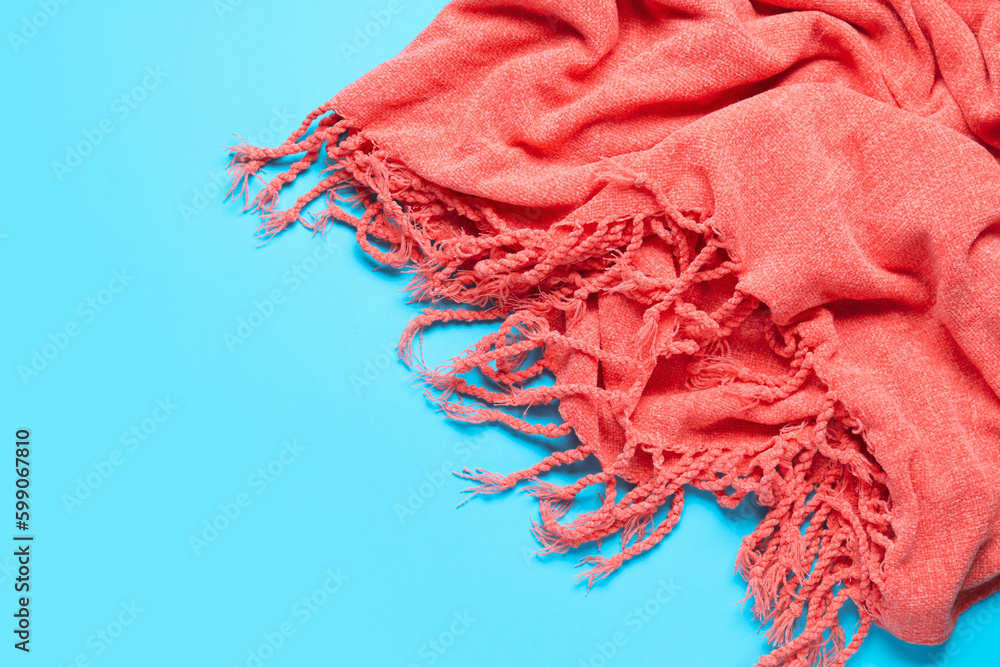 Stylish shawl on color background, closeup