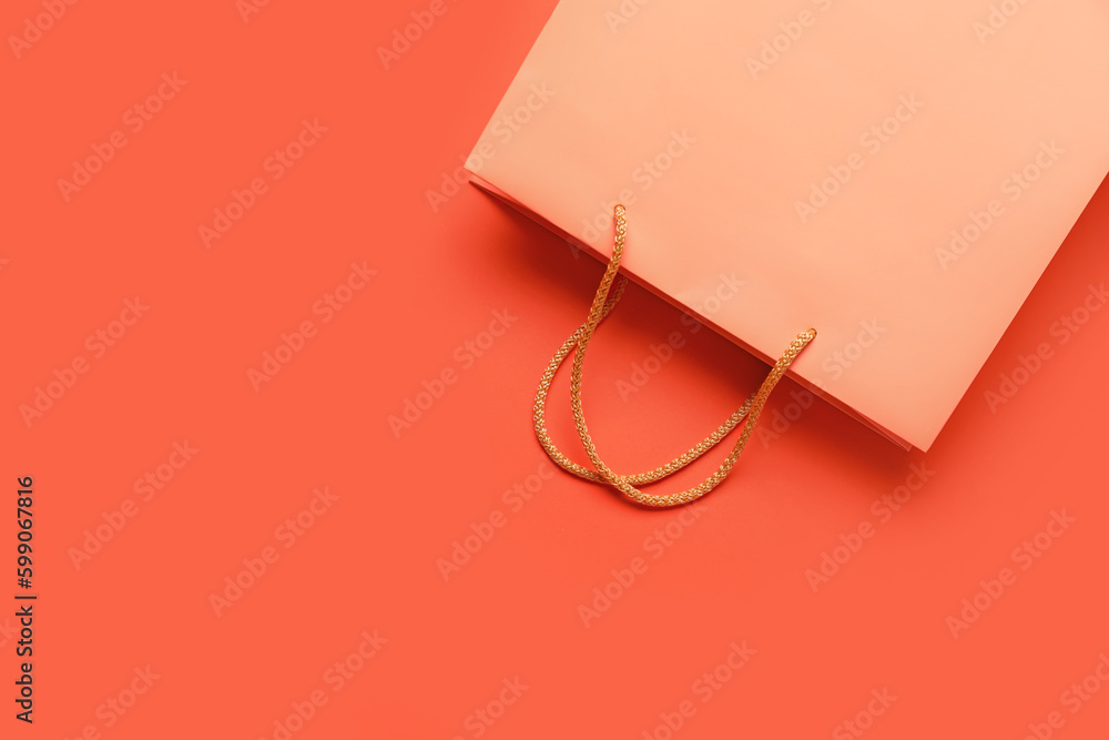 Empty paper bag on color background