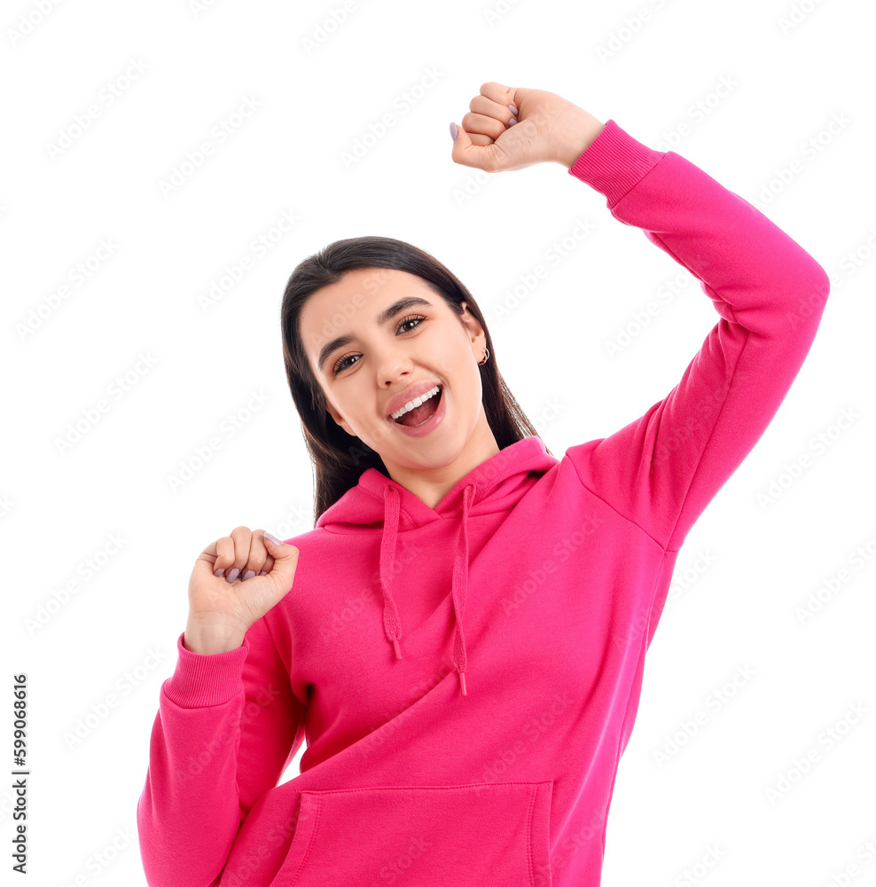 Happy dancing young woman on white background