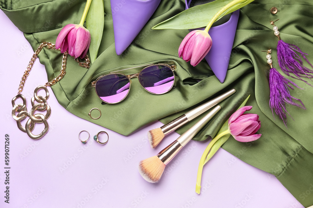 Composition with stylish female accessories, makeup brushes, heels and tulip flowers on color backgr