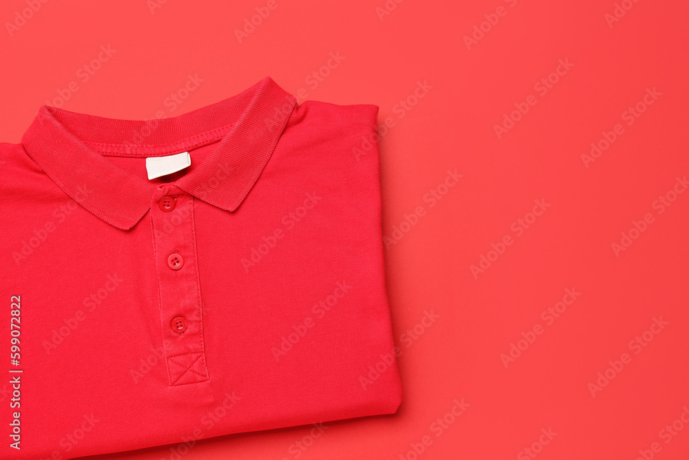 Folded red t-shirt on color background