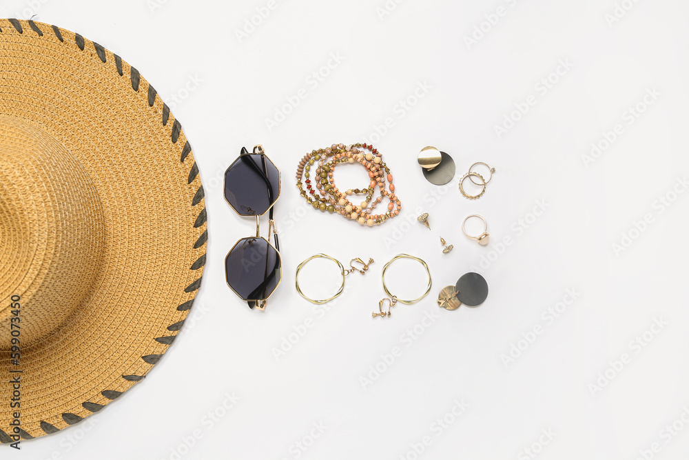 Jewelry with sunglasses and summer hat on white background