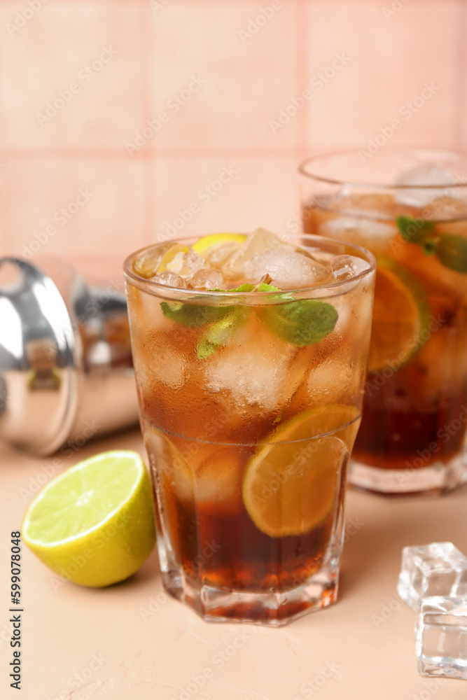 Glass of cold Cuba Libre cocktail on table