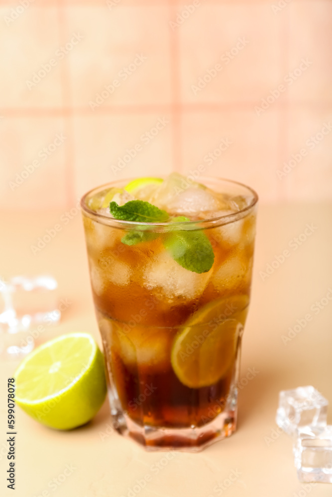 Glass of cold Cuba Libre cocktail on table