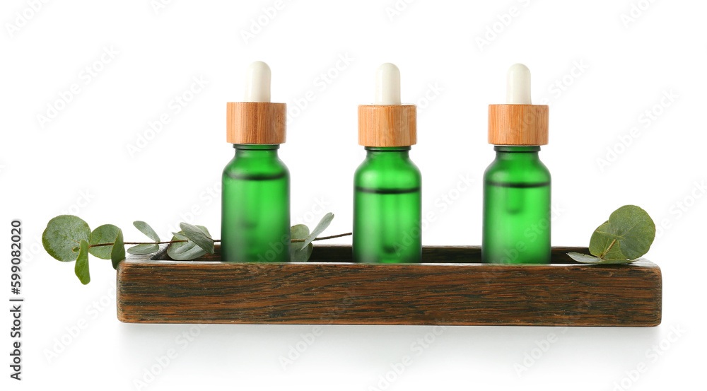 Cosmetic oil with wooden stand and eucalyptus branch on white background