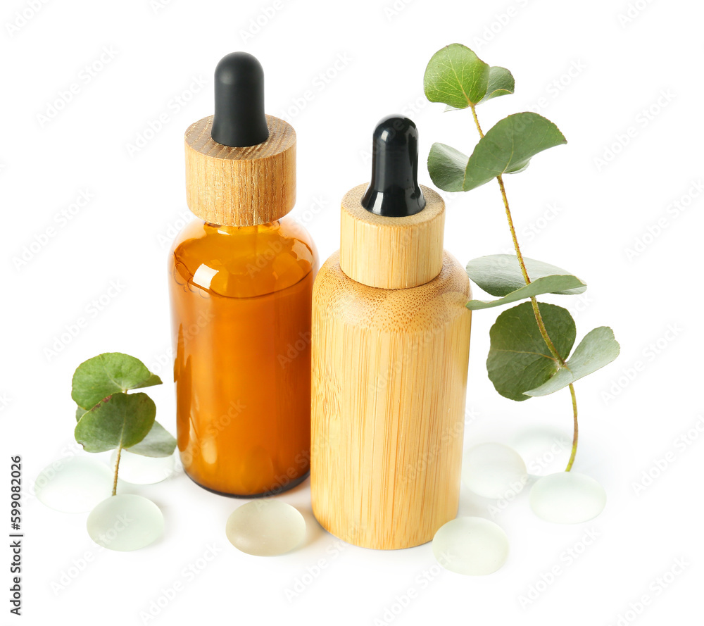 Bottle with cosmetic oil, eucalyptus branch and stones on white background