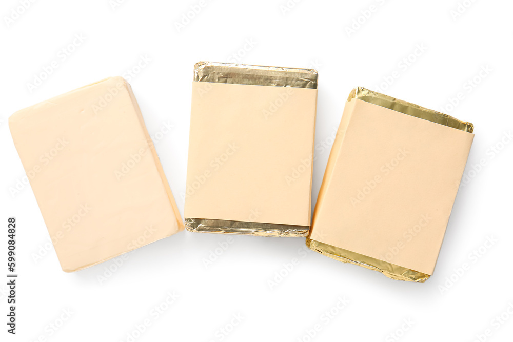 Processed cheese in foil isolated on white background