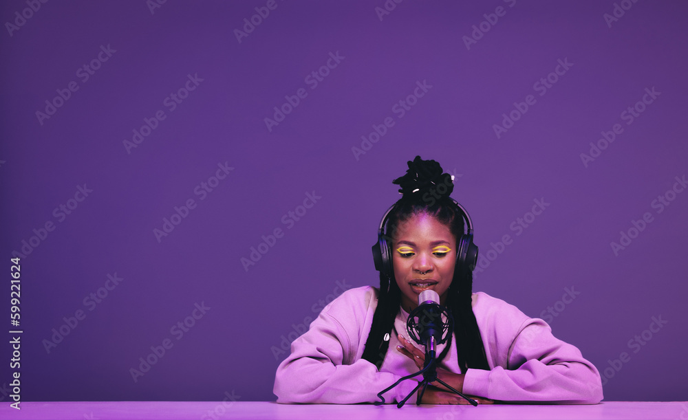 Female podcaster whispering into a microphone in a recording studio