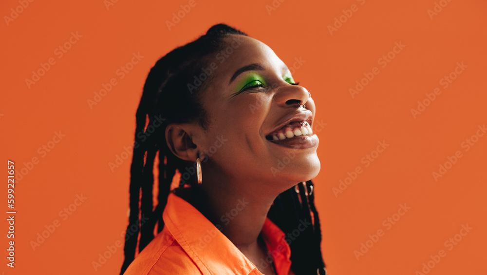 Happy african woman with makeup smiling with her eyes closed