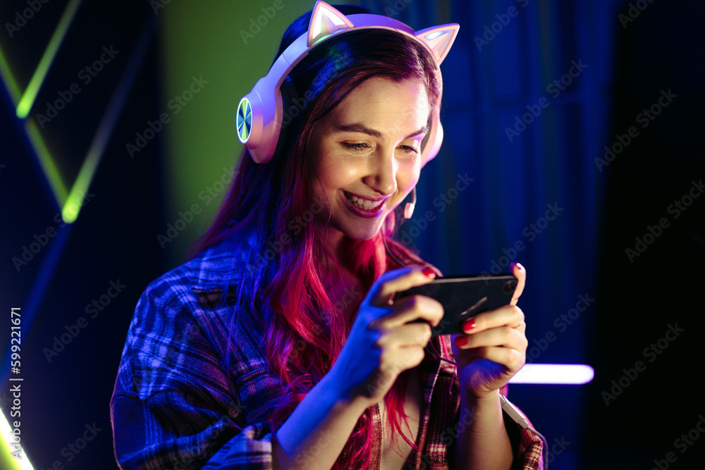 Girl playing a mobile game on her smartphone