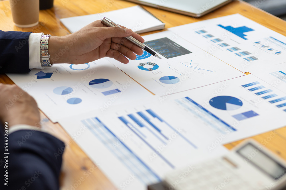 Businessman working on documents on the desk, data analysis of financial figures and business invest