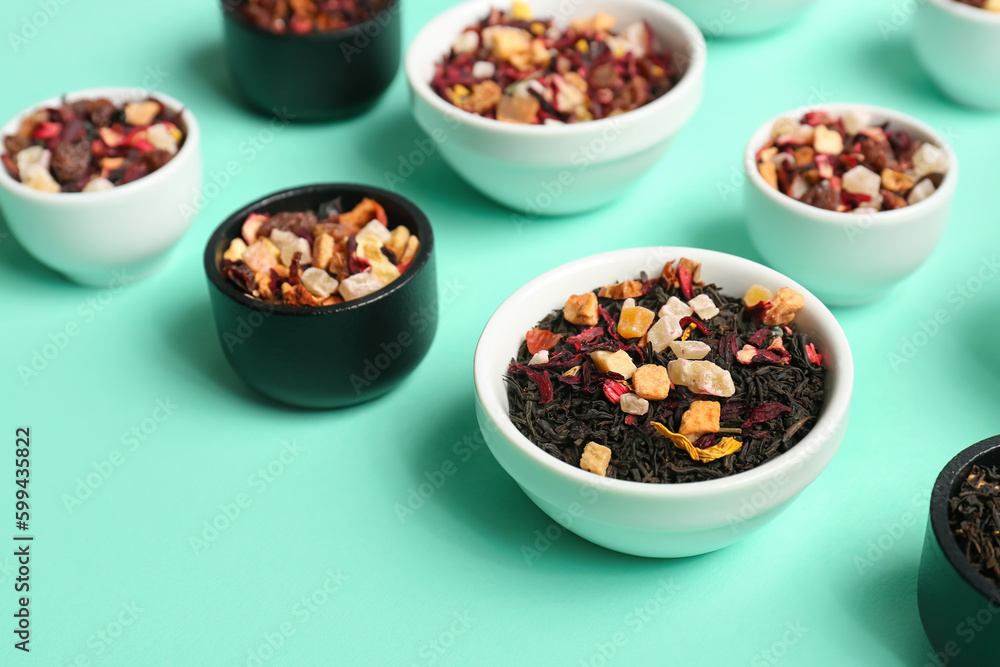 Assortment with different types of dried fruit tea on turquoise background