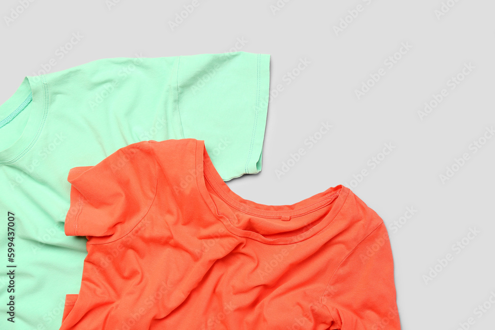 Crumpled t-shirts on light background