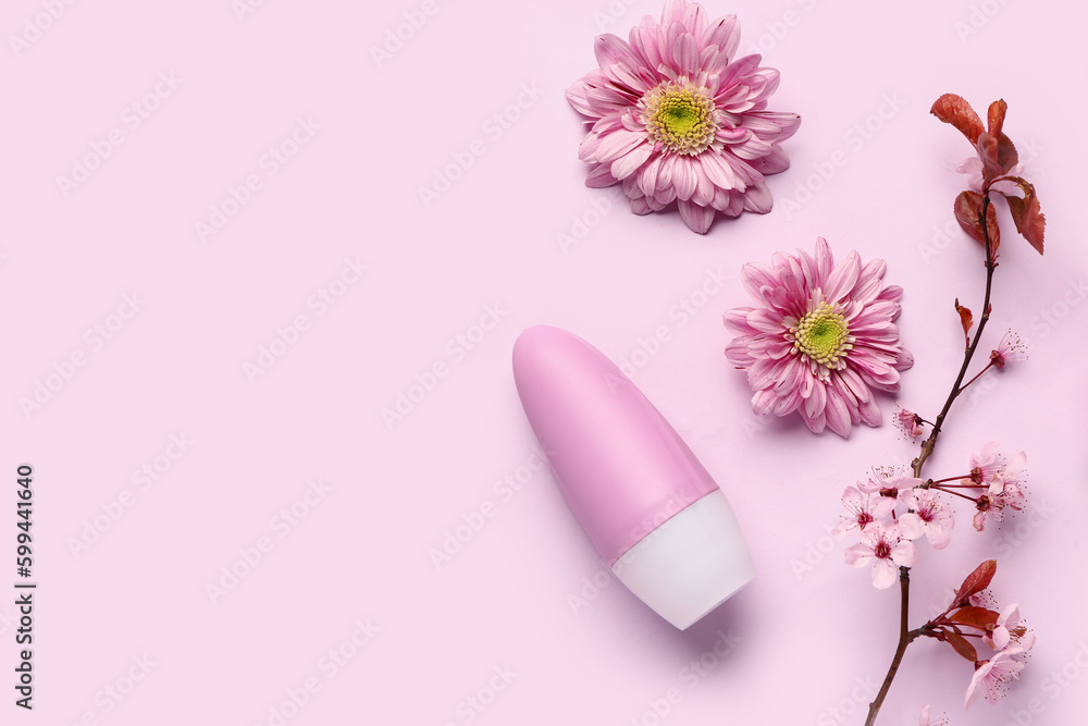 Deodorant with flowers and blooming branch on pink background