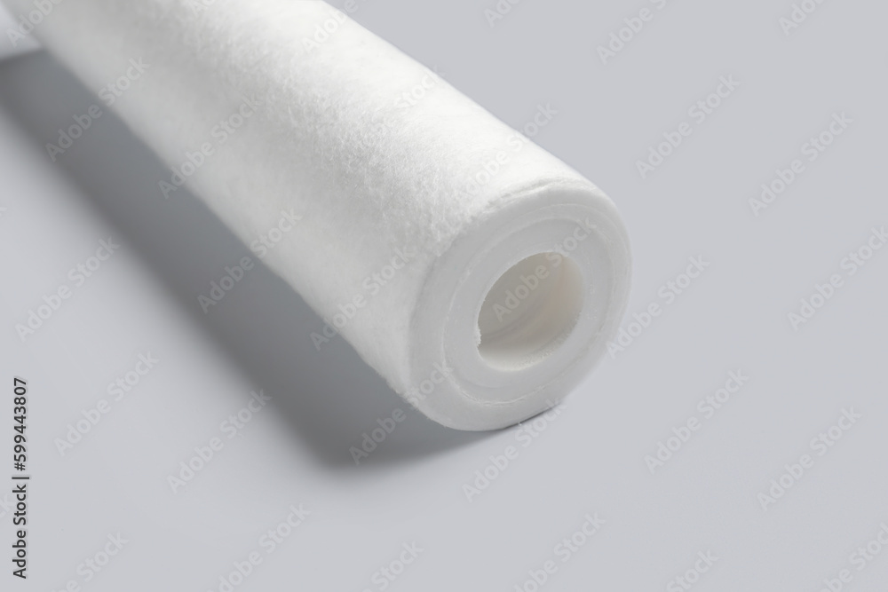 New water filter cartridge on light background, closeup