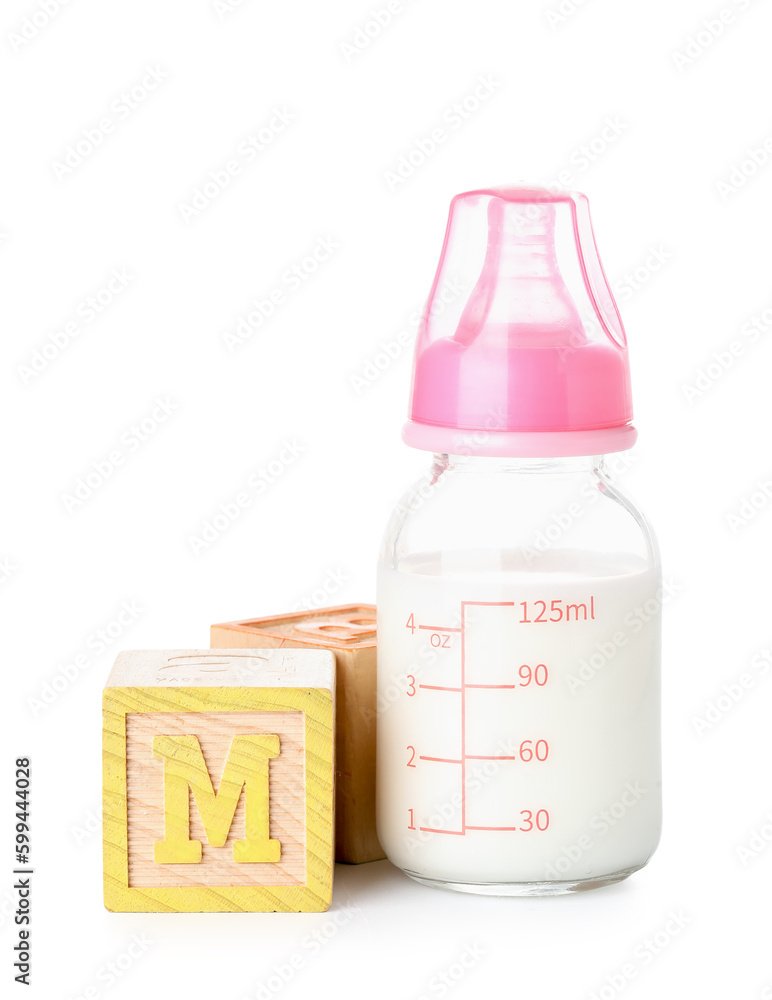 Bottle of milk for baby with wooden cubes isolated on white background