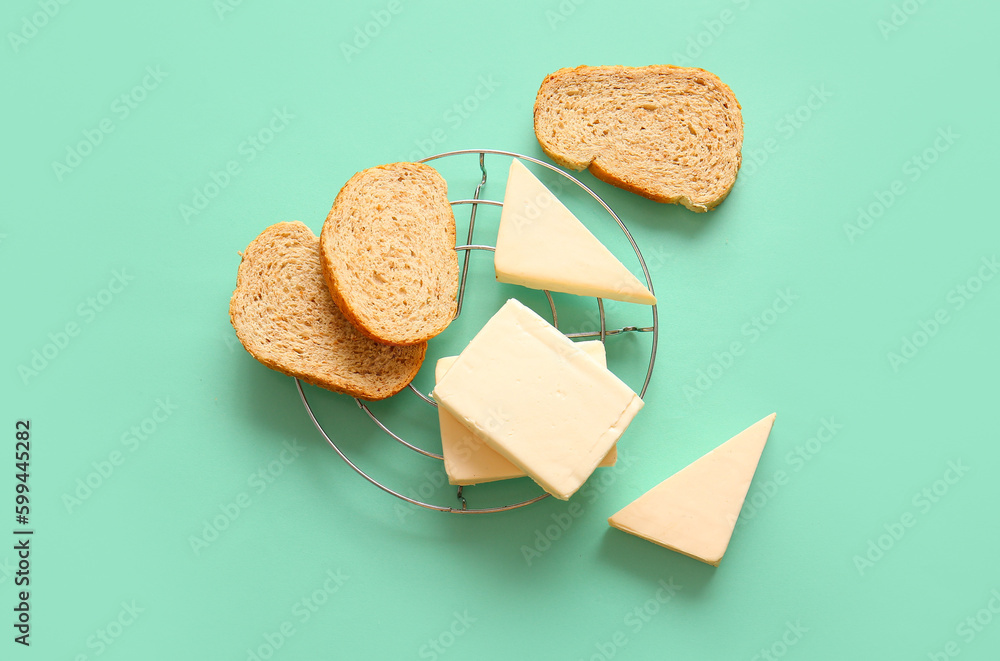 Stand with processed cheese and bread on turquoise background