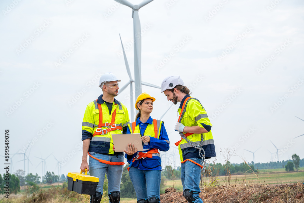 Group of engineers are working with a blueprint in wind turbine farm,Wind power station,Renewable an