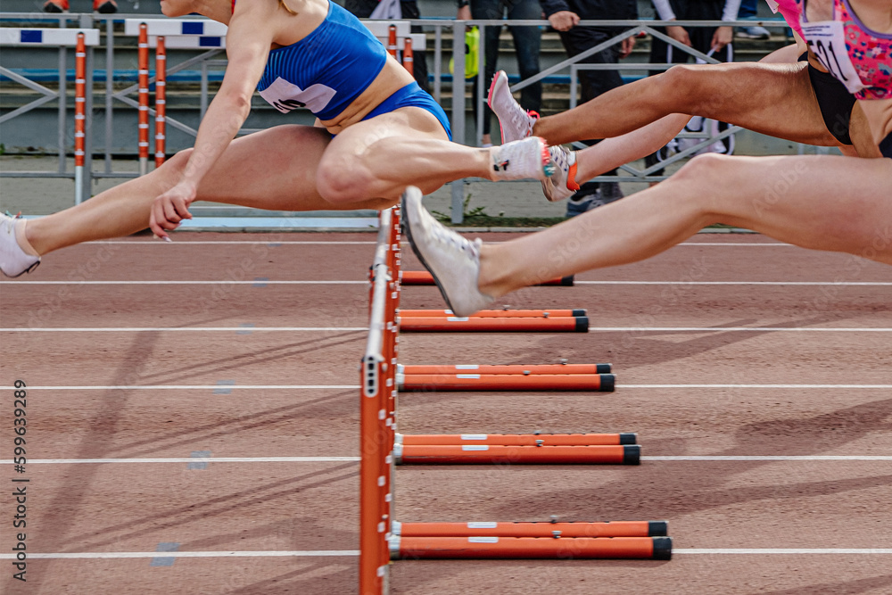 leading woman runner headed running hurdles race in summer athletics championships