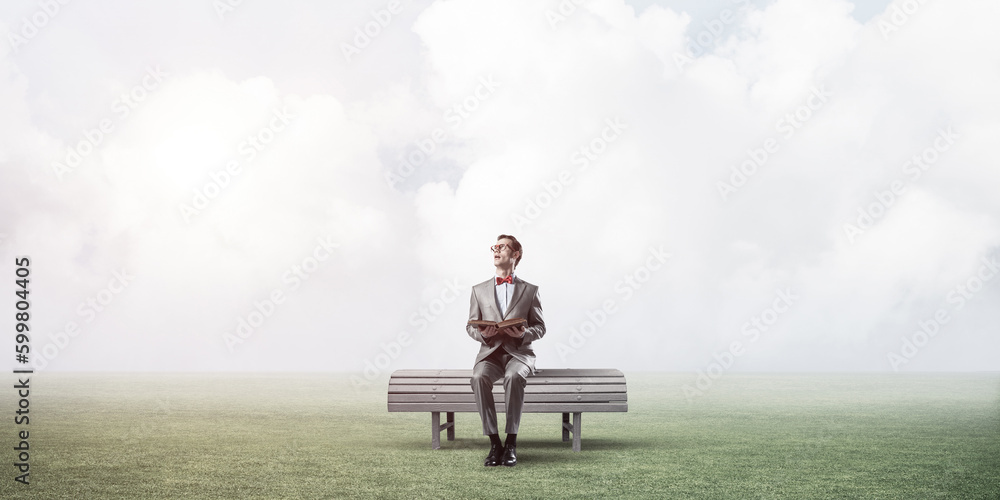 Young businessman or student studying the science in summer park