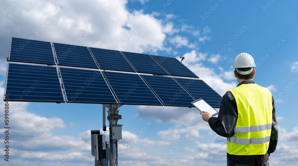 Engineer with tablet computer on a background of solar energy power station	