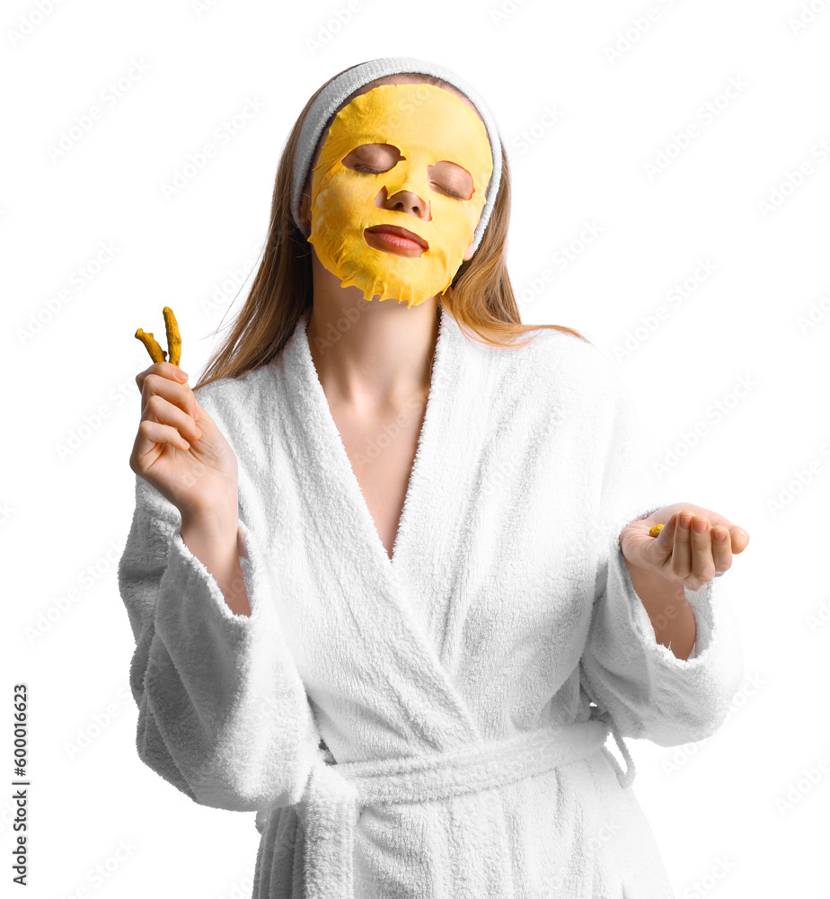 Young woman with turmeric mask and roots on white background